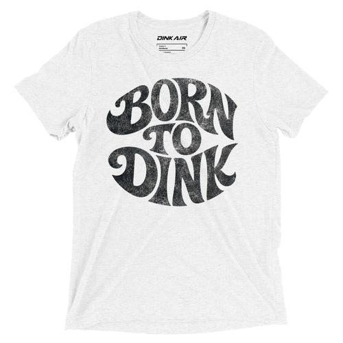 White tri-blend t-shirt featuring a bold vintage-inspired "Born to Dink" graphic across the front in black, designed for pickleball players with a retro athletic style.