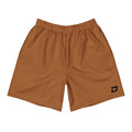 Front view of the Canyon Performance Shorts featuring a warm canyon brown performance fabric, white D Mark logo on the lower left leg, elastic waistband, athletic fit, moisture-wicking material, lightweight four-way stretch construction, and a clean minimalist design for pickleball, tournaments, training, travel, and everyday wear.
