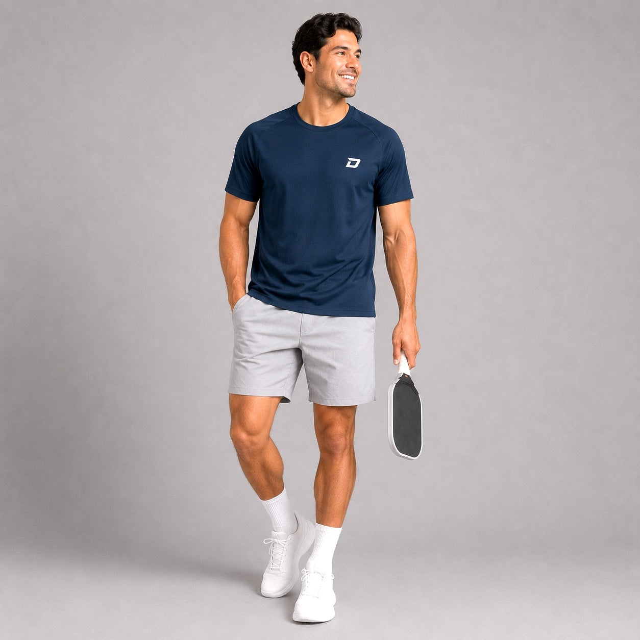 Lifestyle image of a model wearing the navy Classic Performance Tee in a casual athletic setting.