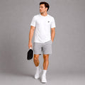 Lifestyle image of a model wearing the white Classic Performance Tee in a casual athletic setting.