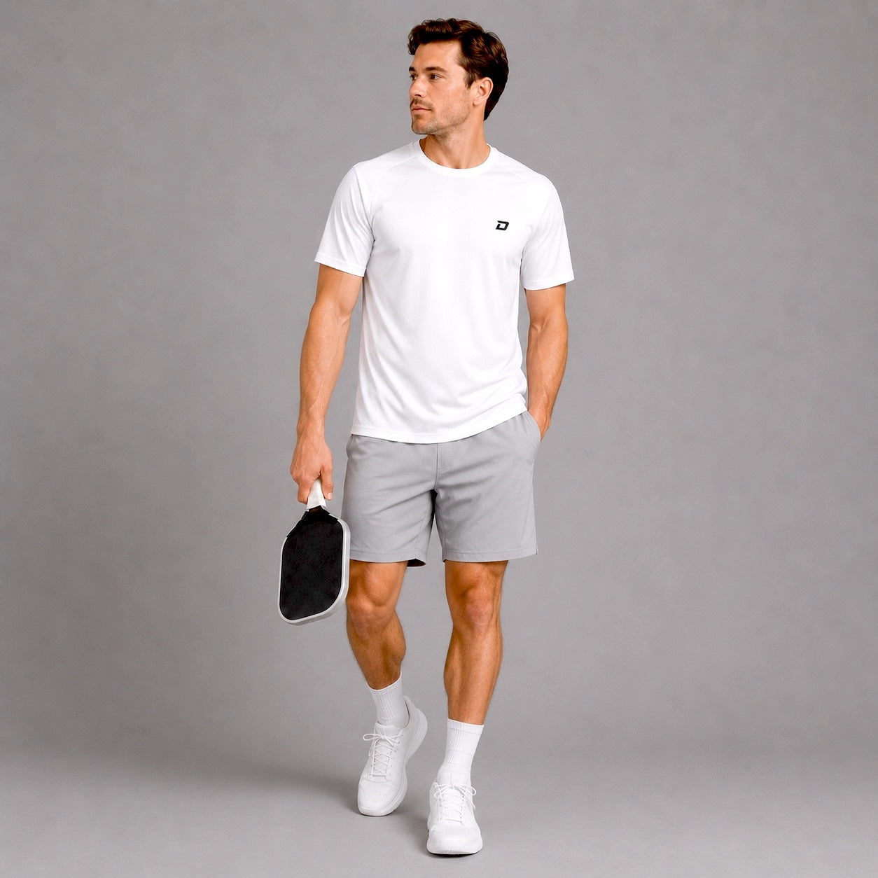 Lifestyle image of a model wearing the white Classic Performance Tee in a casual athletic setting.