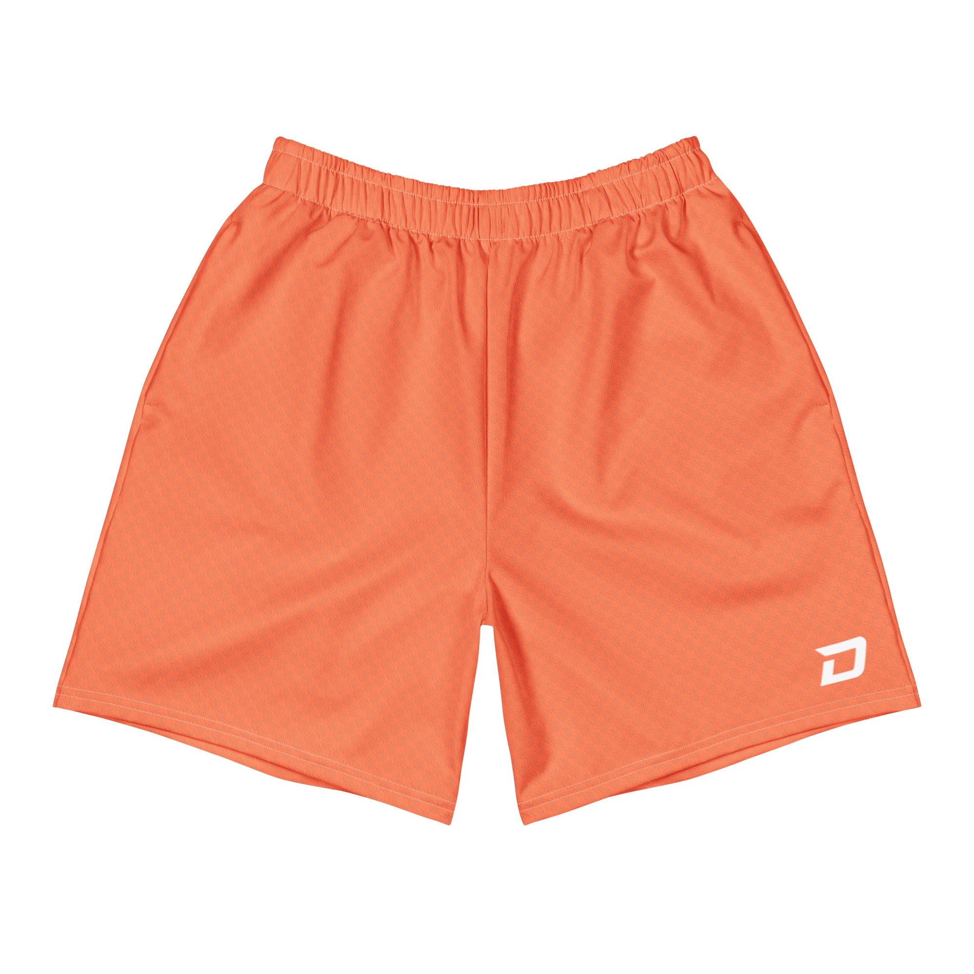 Front view of the Coral Performance Shorts featuring a solid coral performance fabric, a white D Mark logo on the lower left leg, elastic waistband, athletic fit, moisture-wicking material, and a clean minimalist design for pickleball, training, tournaments, and everyday wear.
