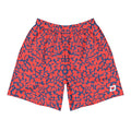 Front view of Dink Air Crimson Performance Shorts featuring a bold crimson and navy abstract pattern with a white D Mark logo on the lower left leg. Premium pickleball performance shorts designed for lightweight comfort, unrestricted movement, and all-day play.