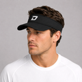 Male model wearing the black D Mark Performance Visor with a white athletic tee, showcasing the embroidered D logo and lightweight design built for comfort and sun protection on and off the pickleball court.