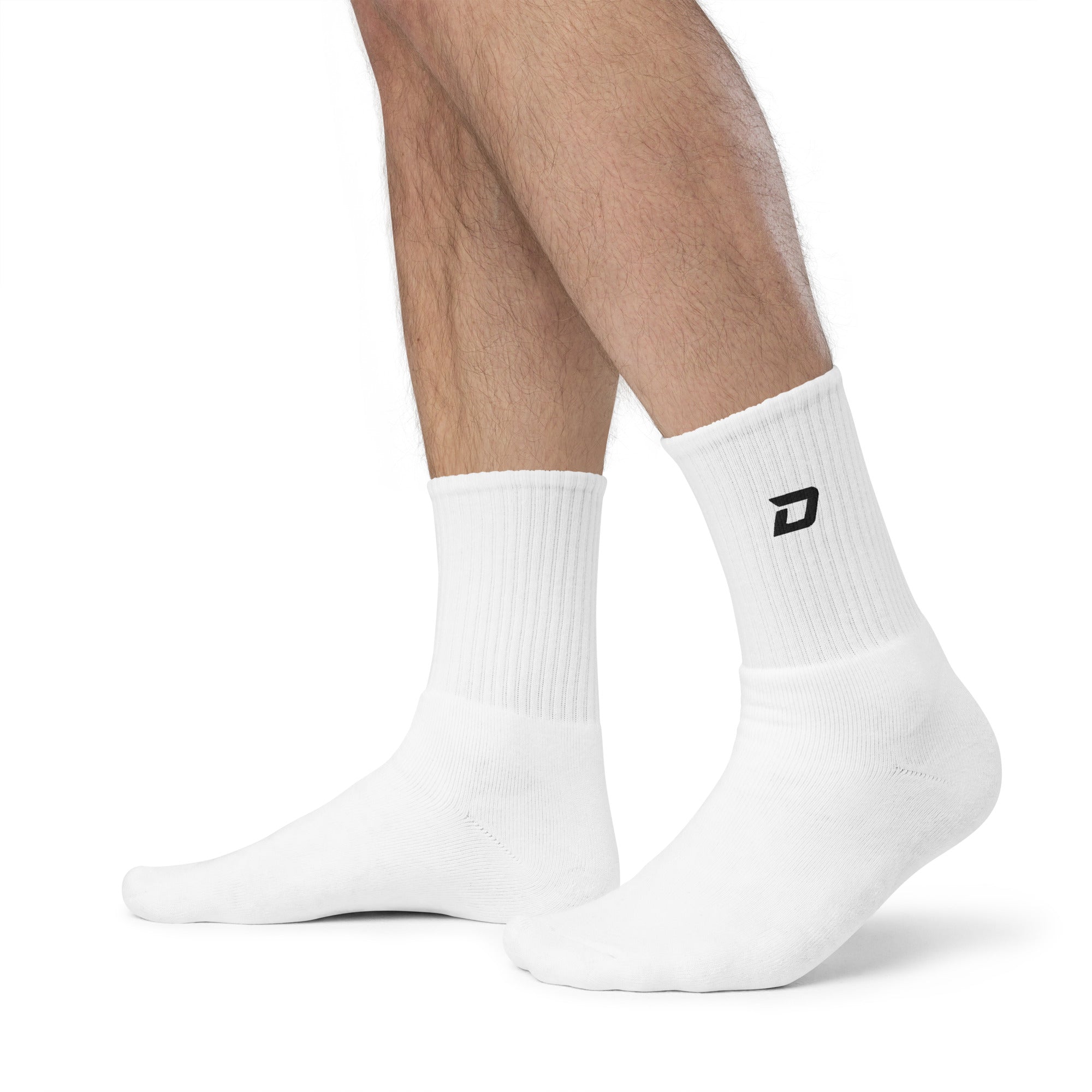 White premium embroidered crew socks featuring the signature D Mark logo, styled for pickleball and everyday wear.