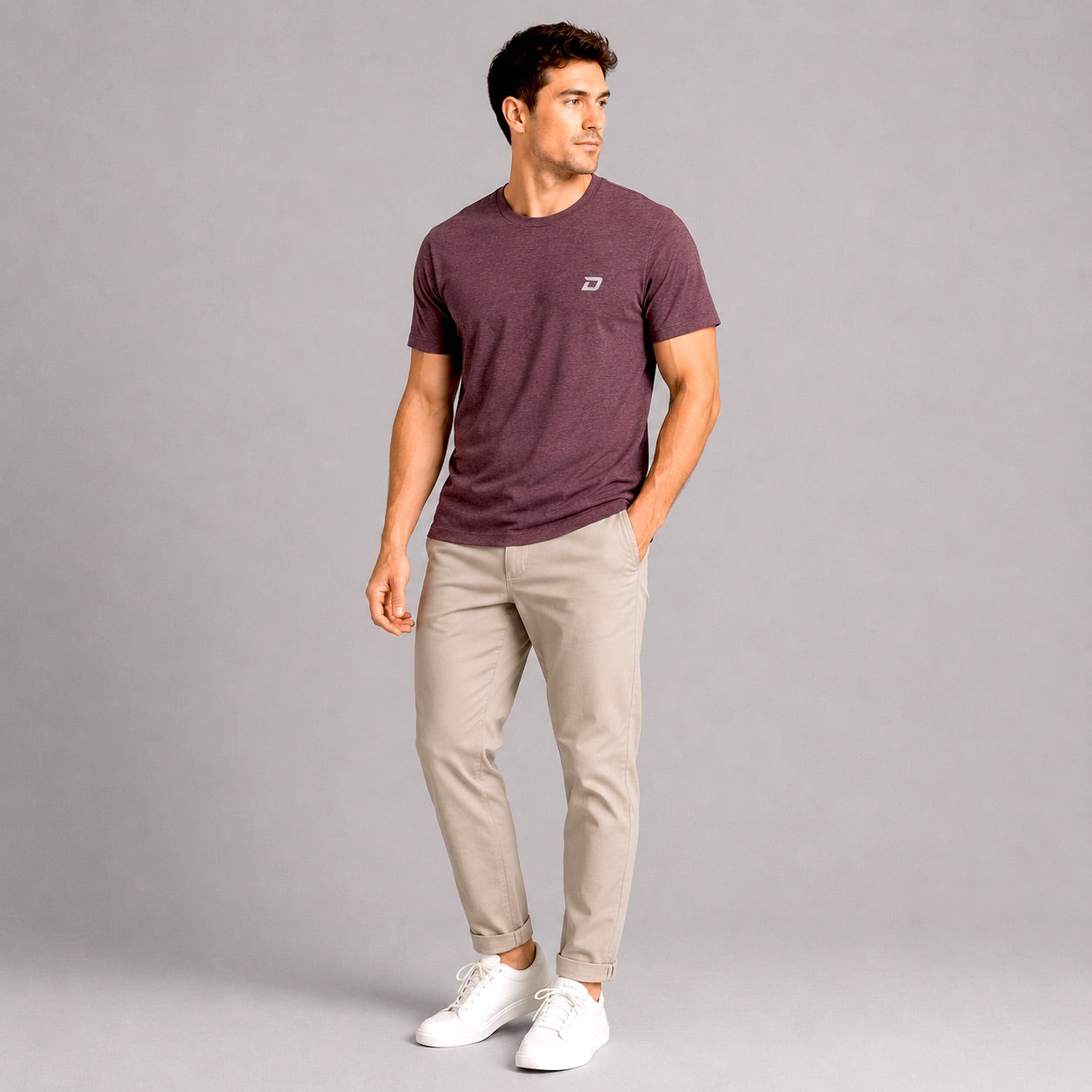 Male model wearing the Dink Air D Mark Tri-Blend Tee in maroon featuring an embroidered D Mark logo in a casual lifestyle setting.