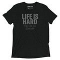 Charcoal black tri-blend t-shirt featuring a bold tonal "Life Is Hard" graphic with "Pickleball" and Dink Air signature script across the front.
