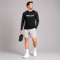 Male model wearing the Midnight Performance Long Sleeve Tee and white performance shorts in an athletic lifestyle setting.