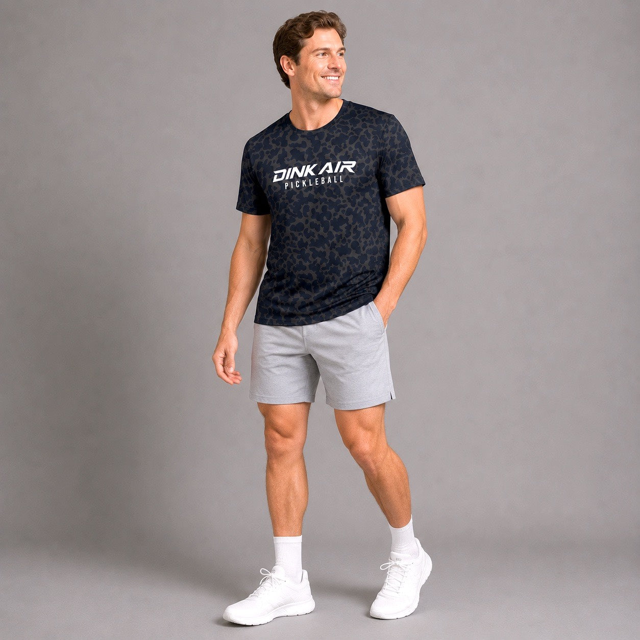Male model wearing the Midnight Performance Tee and white performance shorts in an athletic lifestyle setting.