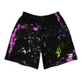 Black performance pickleball shorts featuring a vibrant neon paint-splatter pattern in pink, blue, green, and white with lightweight athletic construction.