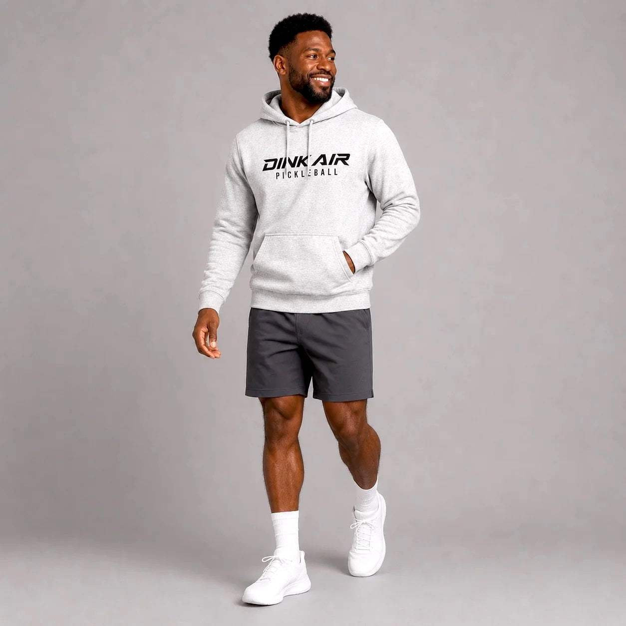 Male model wearing the Signature Pickleball Hoodie in a premium lifestyle setting, showcasing the minimalist Signature Pickleball chest graphic for everyday wear on and off the court.