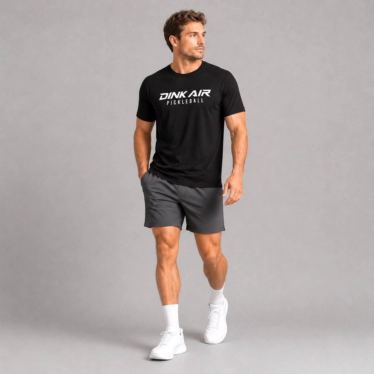 Lifestyle image of a model wearing the black Signature Pickleball Tee in a casual athletic setting.